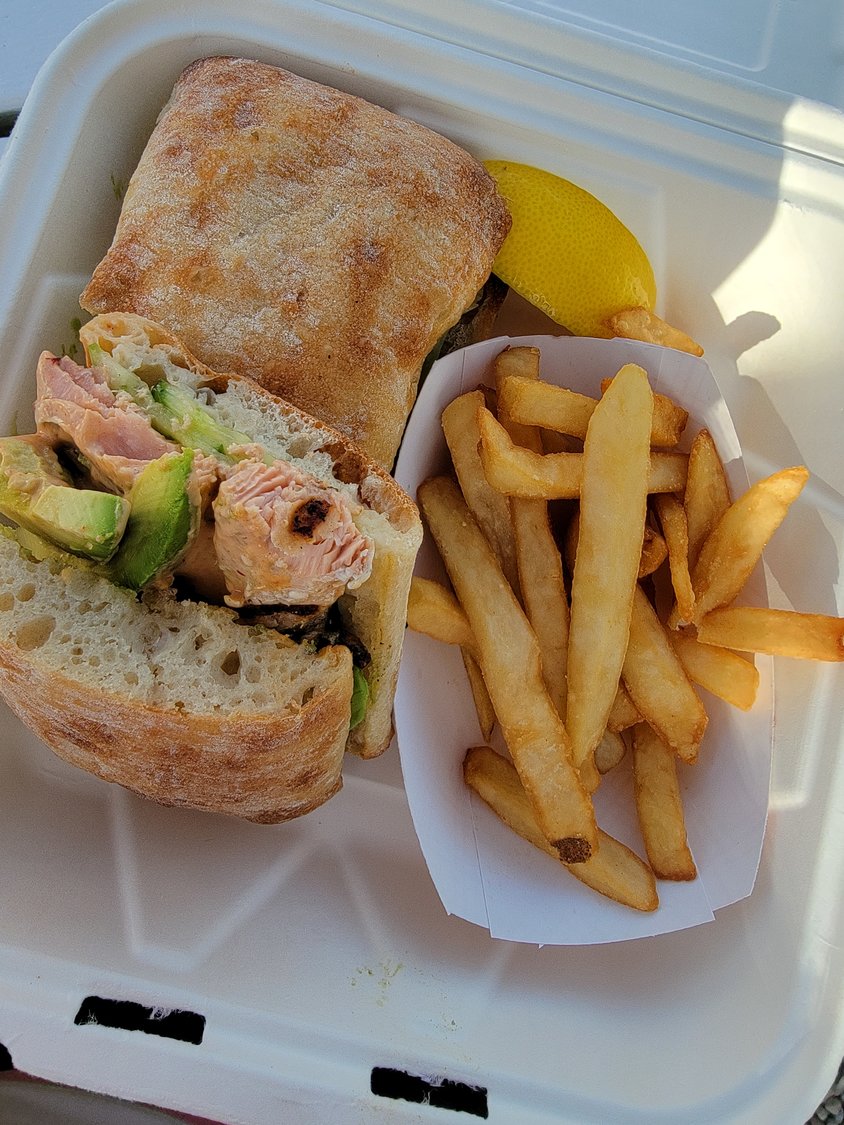 The salmon sandwich is a perfect way to usher in the summer weekend after a long week at work pining for the beach.